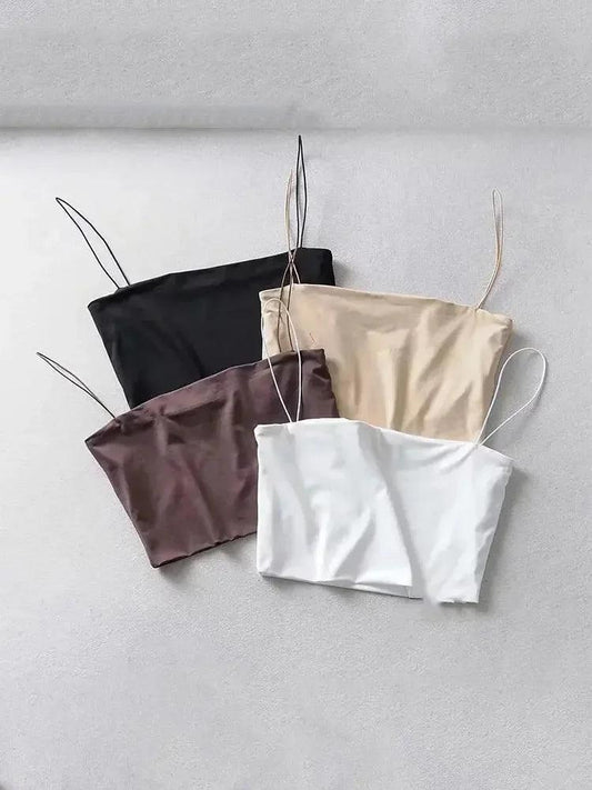 Women's satin camisole tops in black, beige, mauve, and white — sleek, adjustable straps, soft fabric