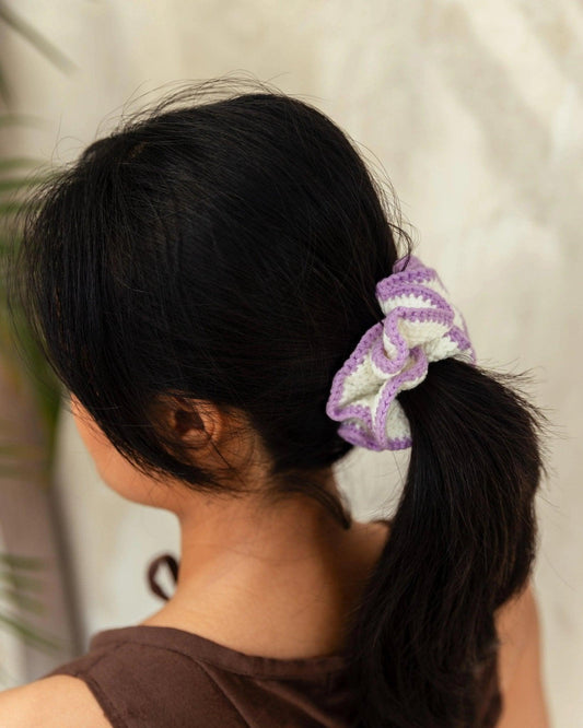Purple and white knitted scrunchie in woman's ponytail, fashion hair accessory