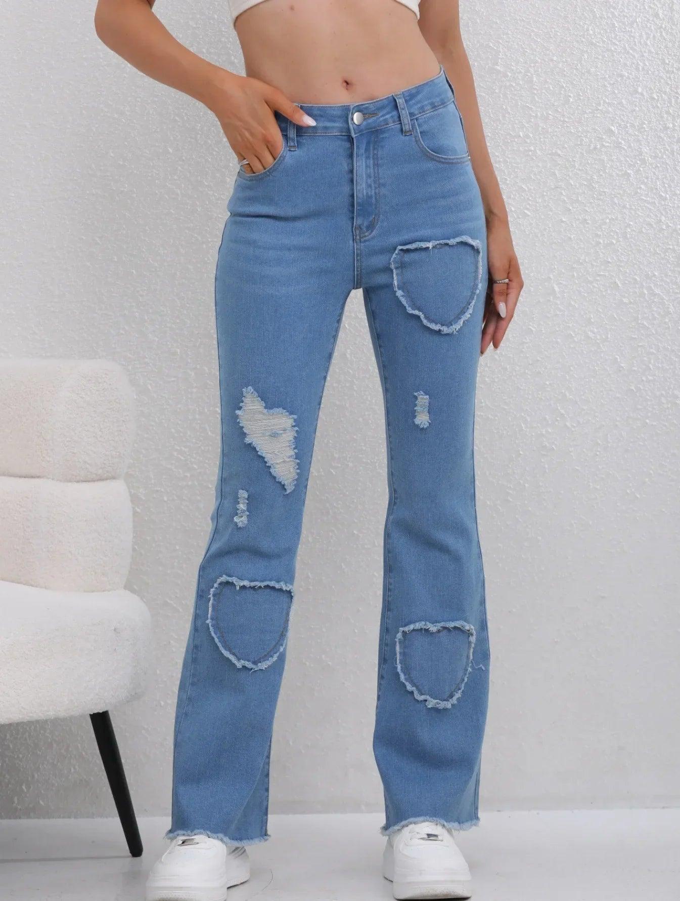 Women's high-waist distressed jeans with heart-shaped rips, flared legs, and frayed hems for trendy fashion