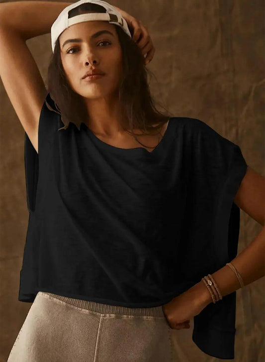 Woman in black oversized t-shirt and white cap, casual fashion style