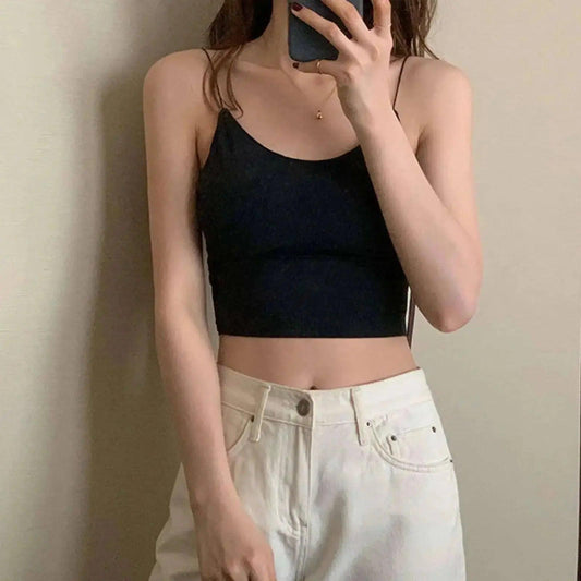Woman in black crop top and white jeans, stylish summer fashion outfit