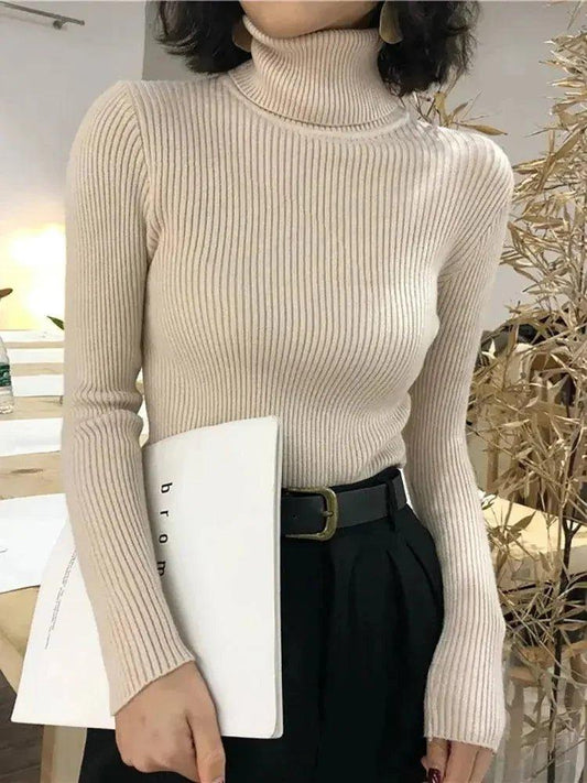 Cream ribbed turtleneck sweater for women, paired with black high-waist pants and belt, stylish office look