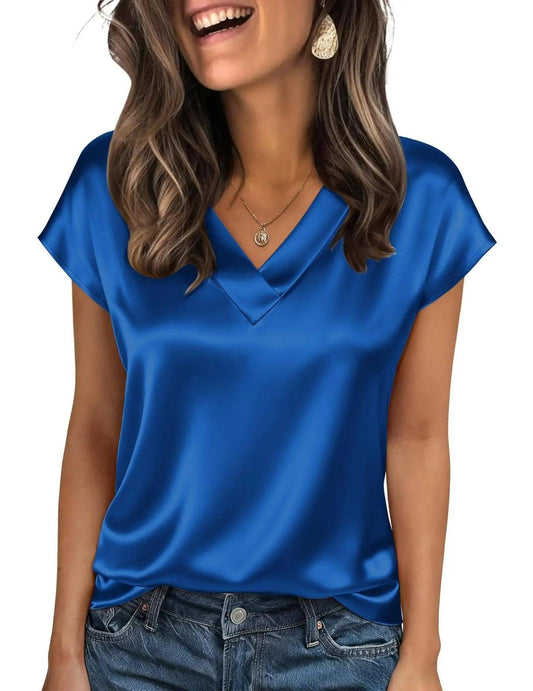 Woman wearing blue satin V-neck top with short sleeves, paired with jeans, for casual fashion