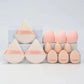 Set of pink and beige makeup sponges with ribbon accents for beauty application