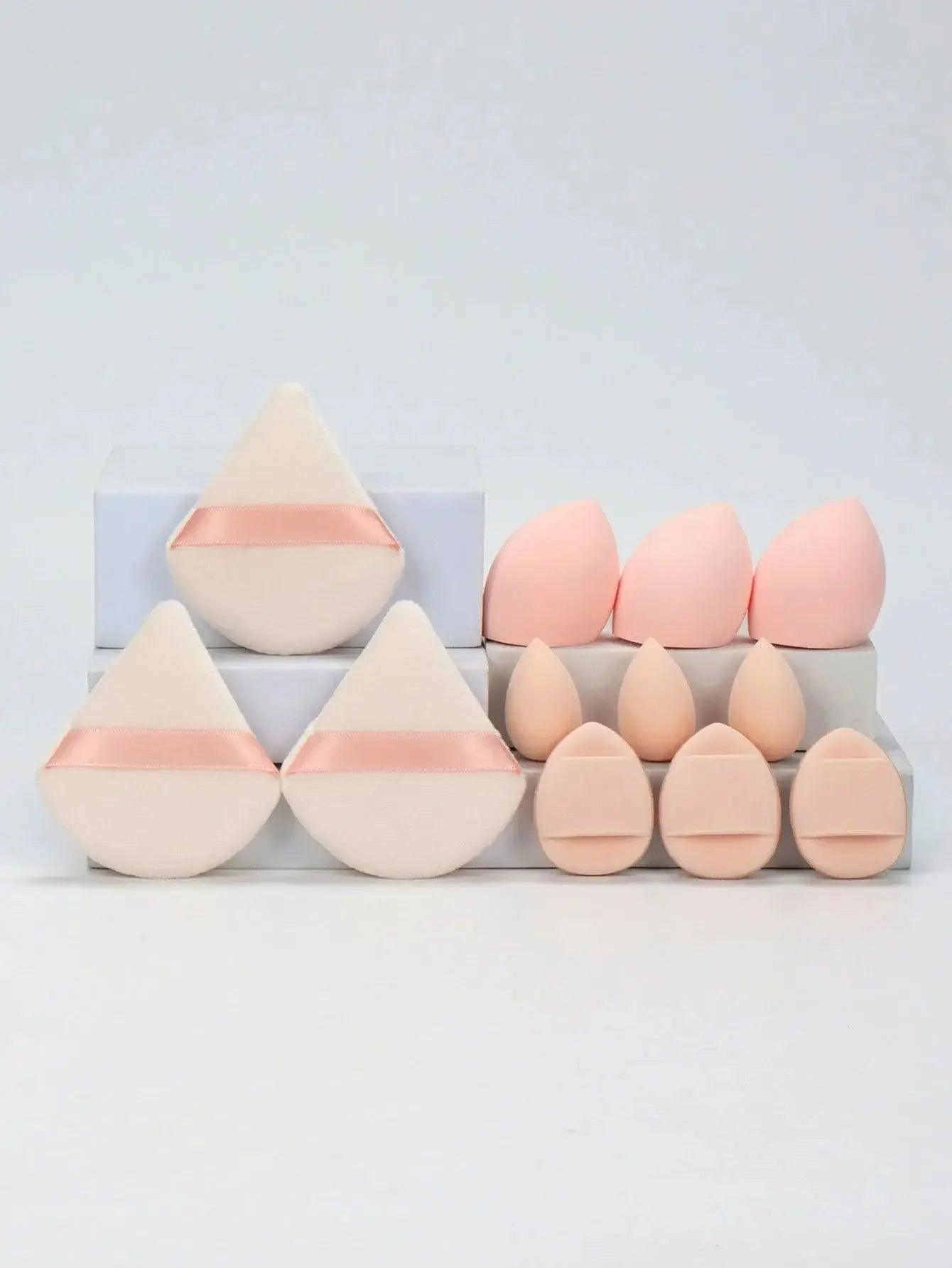 Set of pink and beige makeup sponges with ribbon accents for beauty application