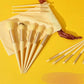 Luxury makeup brushes set with gold accents, cream handles, and velvet pouch on vibrant yellow background