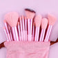 Pink makeup brush set with rose gold handles in soft pouch, perfect for beauty and fashion lovers