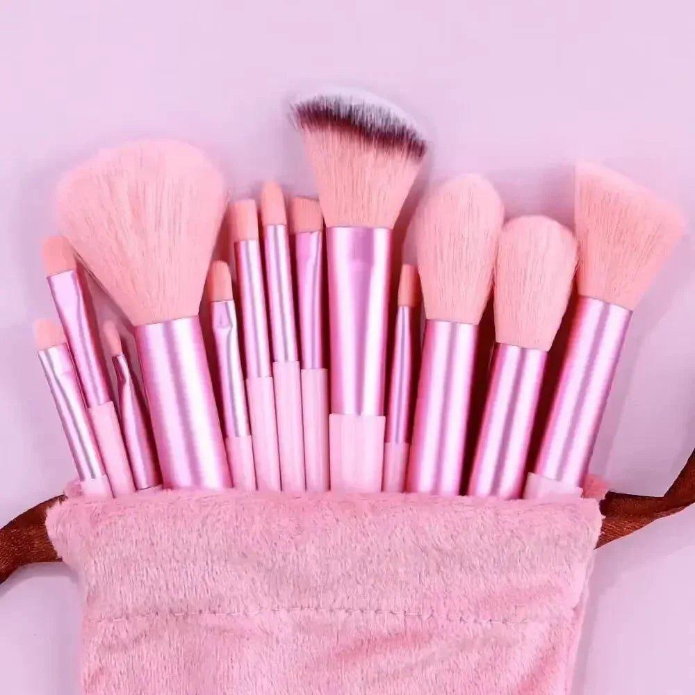 Pink makeup brush set with rose gold handles in soft pouch, perfect for beauty and fashion lovers