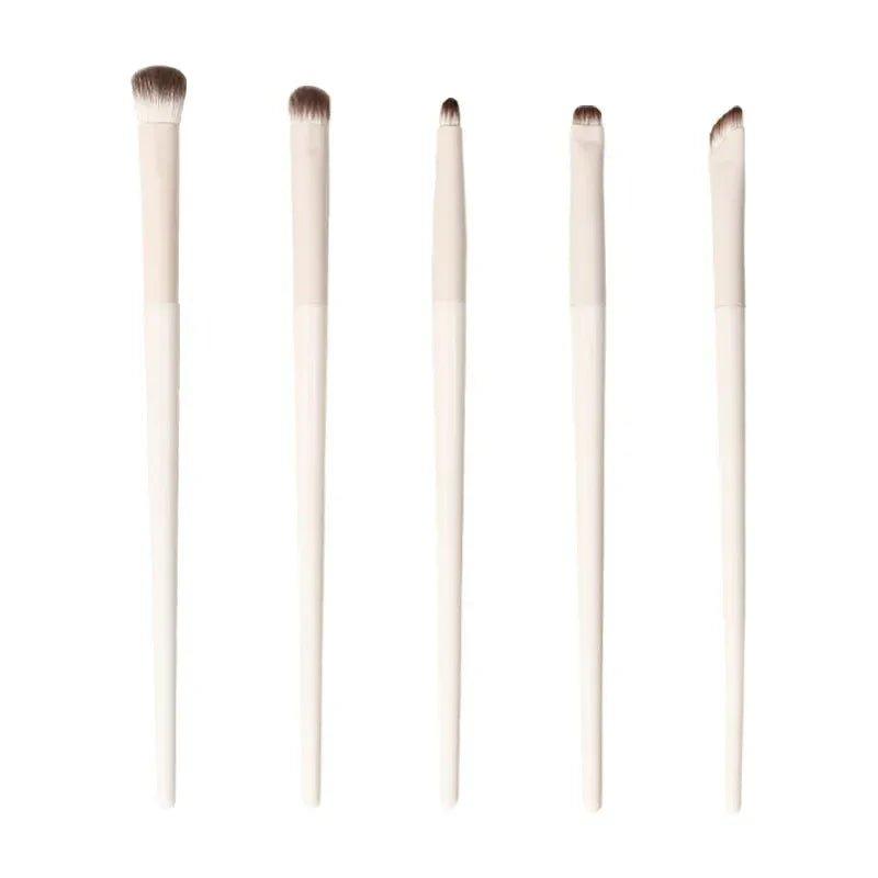 Set of 5 white-handled makeup brushes for eyeshadow and blending, perfect for women's beauty routines