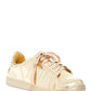 Shiny gold women's fashion sneaker with pink laces and perforated details