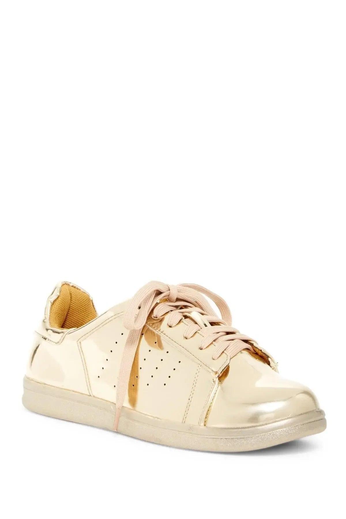 Shiny gold women's fashion sneaker with pink laces and perforated details
