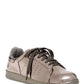Women's metallic gray patent leather sneakers with black laces and perforated details