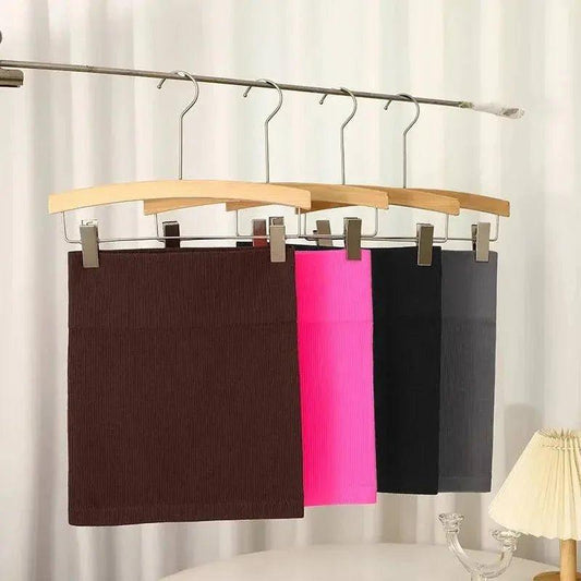 Women's ribbed mini skirts in brown, pink, black, gray on hangers, fashion apparel