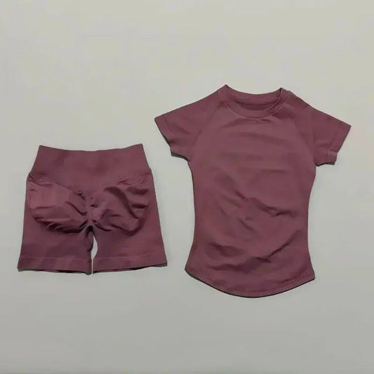 Women's mauve activewear set with high-waisted shorts and short-sleeve top, perfect for fitness and casual wear