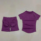 Purple women's workout set with ruched shorts and short-sleeve top for fitness fashion