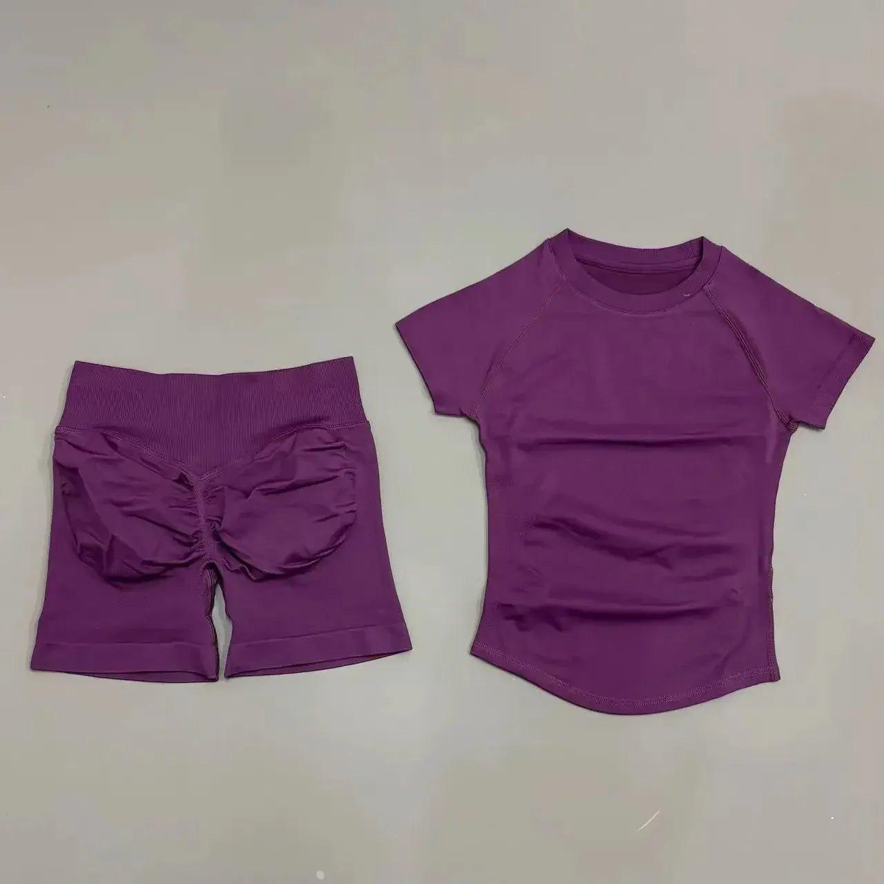 Purple women's workout set with ruched shorts and short-sleeve top for fitness fashion