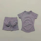 Lavender women's activewear set with ruched shorts and short-sleeve top, perfect for fitness and casual wear.