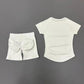 White women's athletic set with padded shorts and raglan tee for fitness or casual wear