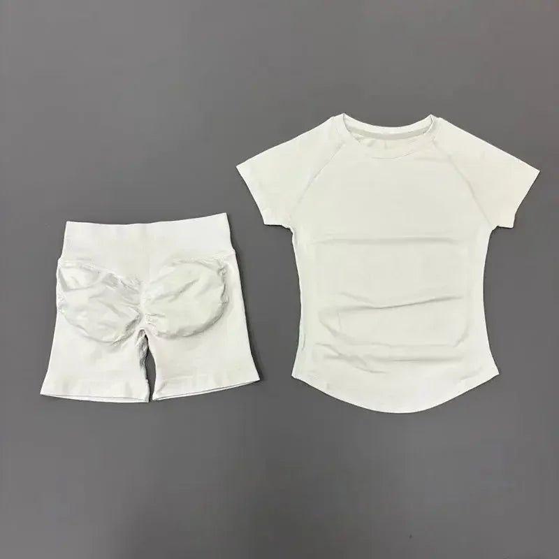 White women's athletic set with padded shorts and raglan tee for fitness or casual wear