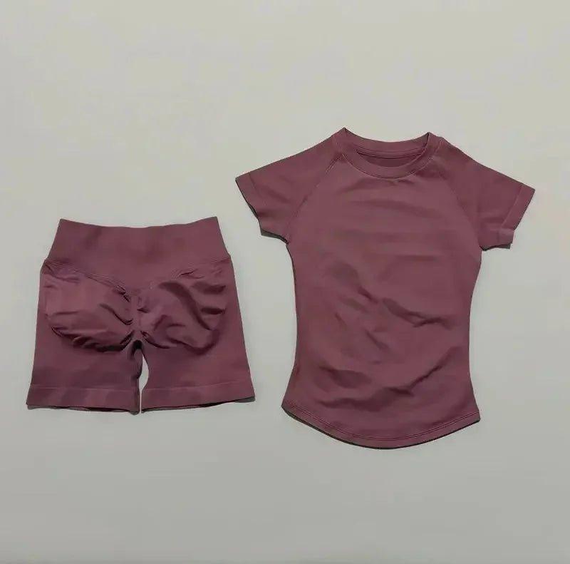 Women's mauve activewear set with short-sleeve top and high-waisted shorts, perfect for gym or yoga