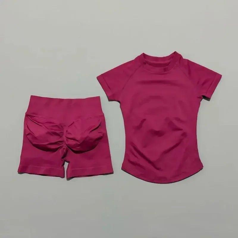 Pink women's fashion activewear set with high-waist shorts and short-sleeve top