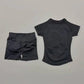 Black women's athletic set: short sleeve top and high-waisted shorts for fitness or casual wear
