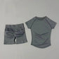 Gray women's athletic set: short-sleeve top and ruched biker shorts for workout or casual wear