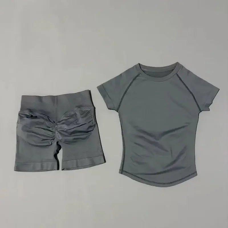 Gray women's athletic set: short-sleeve top and ruched biker shorts for workout or casual wear