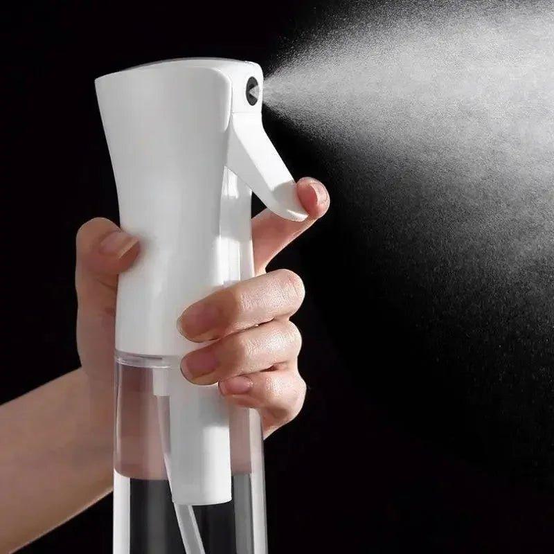 Hand holding white mist spray bottle for beauty and fashion skincare routine