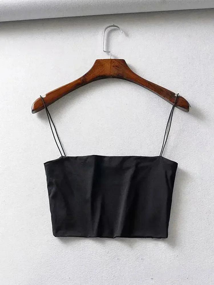 Black satin crop top with thin straps on wooden hanger, women's fashion