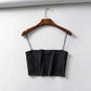 Black satin crop top with thin straps on wooden hanger, women's fashion