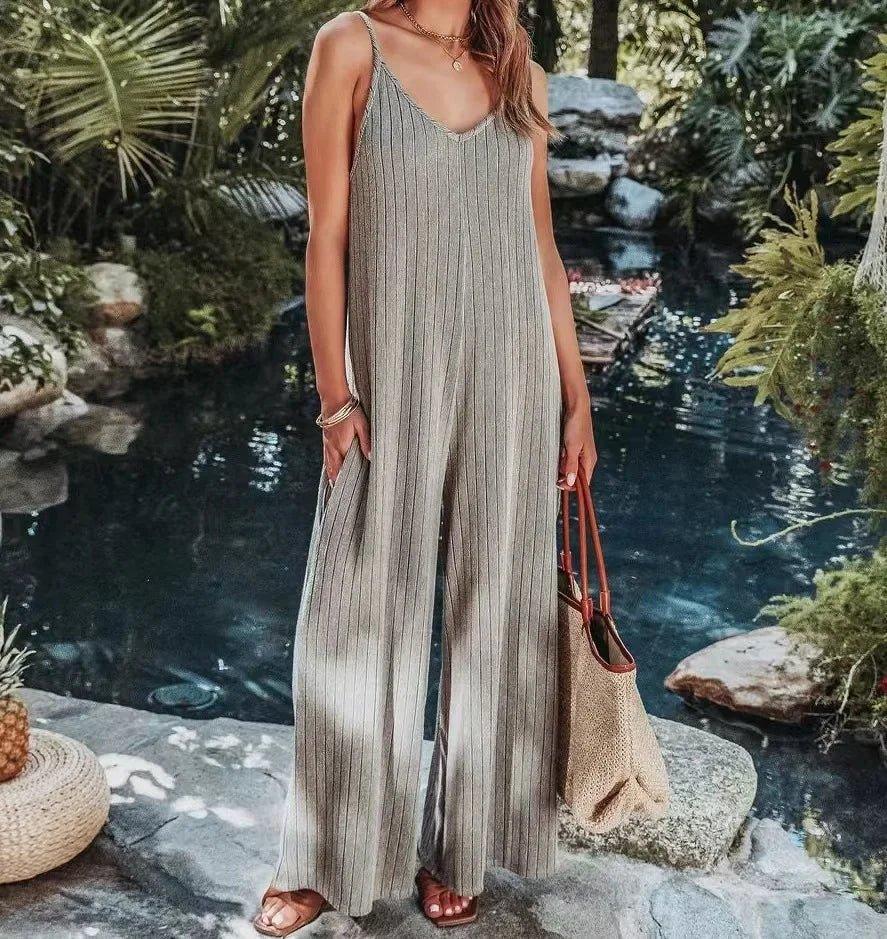 Woman in striped sleeveless jumpsuit by poolside, summer fashion outfit with woven bag