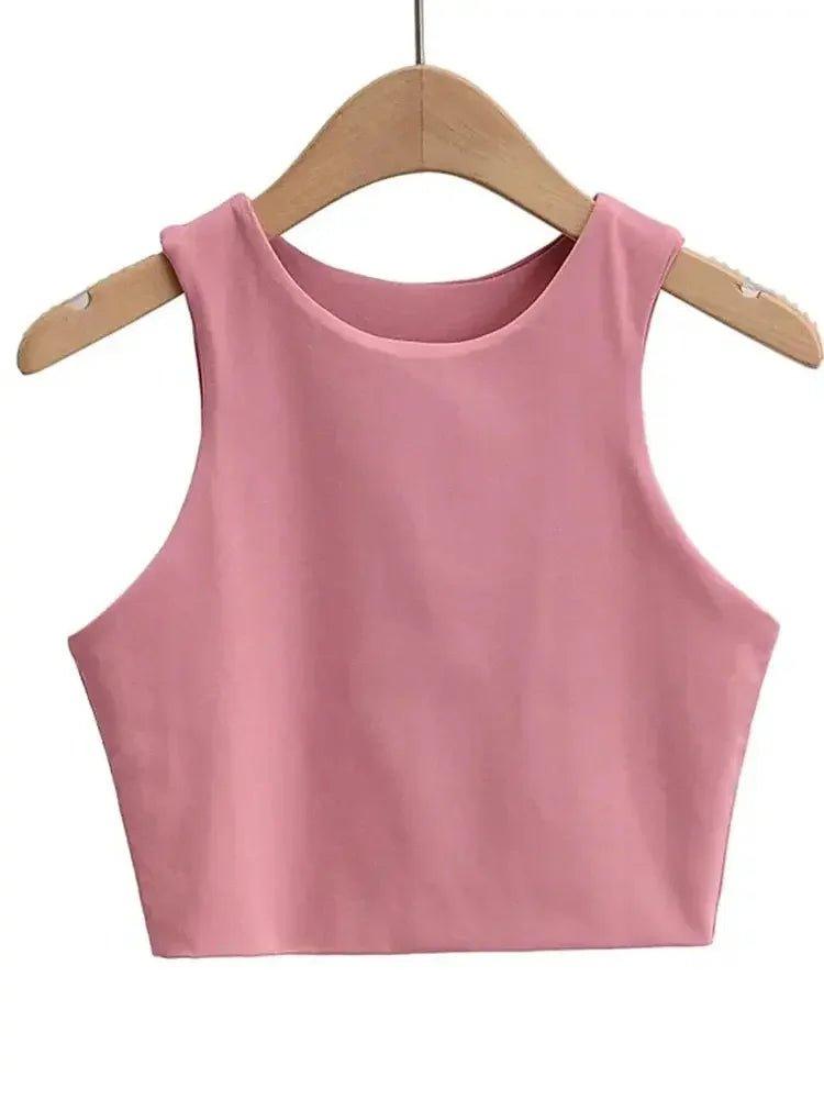 Pink sleeveless crop top for women, stylish summer fashion on wooden hanger