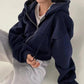 Navy blue zip-up hoodie for women, cozy oversized fit with front pockets, layered over white tee