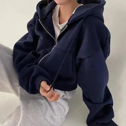 Navy blue zip-up hoodie for women, cozy oversized fit with front pockets, layered over white tee