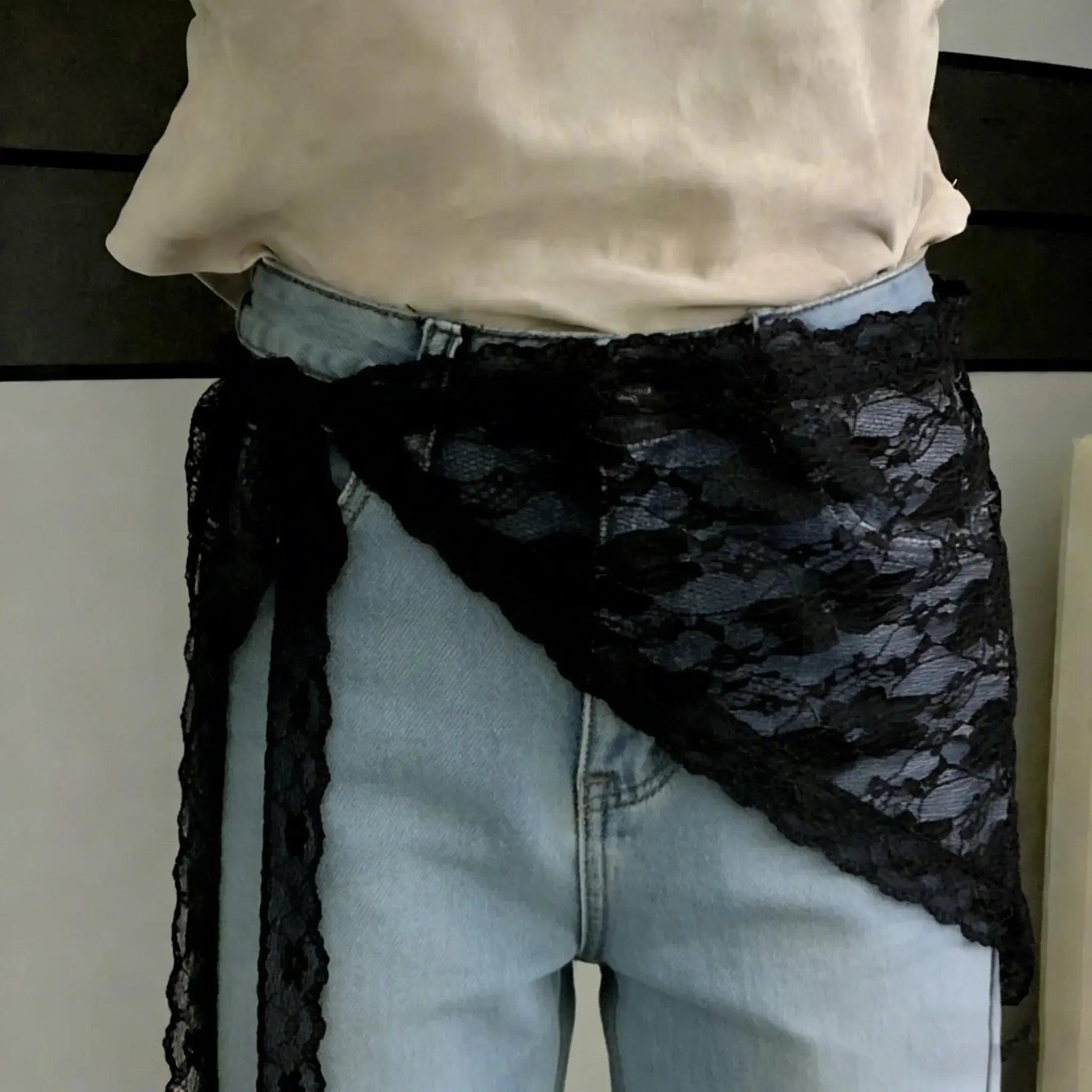 Black lace waist wrap tied over light wash jeans, fashion accessory for women
