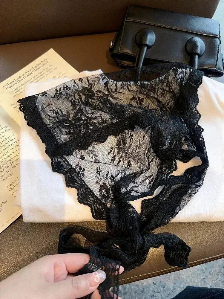 Black lace lingerie with floral pattern, tied bow, styled with handbag and book for women's fashion