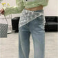 Woman in green striped crop top, lace waist scarf, and wide-leg jeans for trendy fashion look
