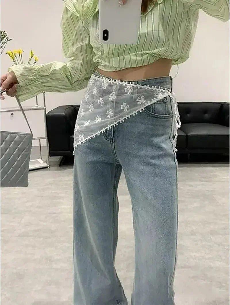 Woman in green striped crop top, lace waist scarf, and wide-leg jeans for trendy fashion look