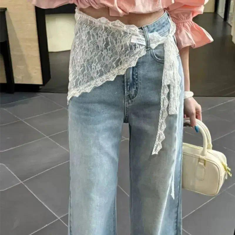 Lace waist wrap over high-rise jeans, pink ruffle top, cream handbag — women's fashion outfit