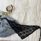 Black and white lace lingerie set with denim shorts, styled on white bedding with coffee cup and flowers