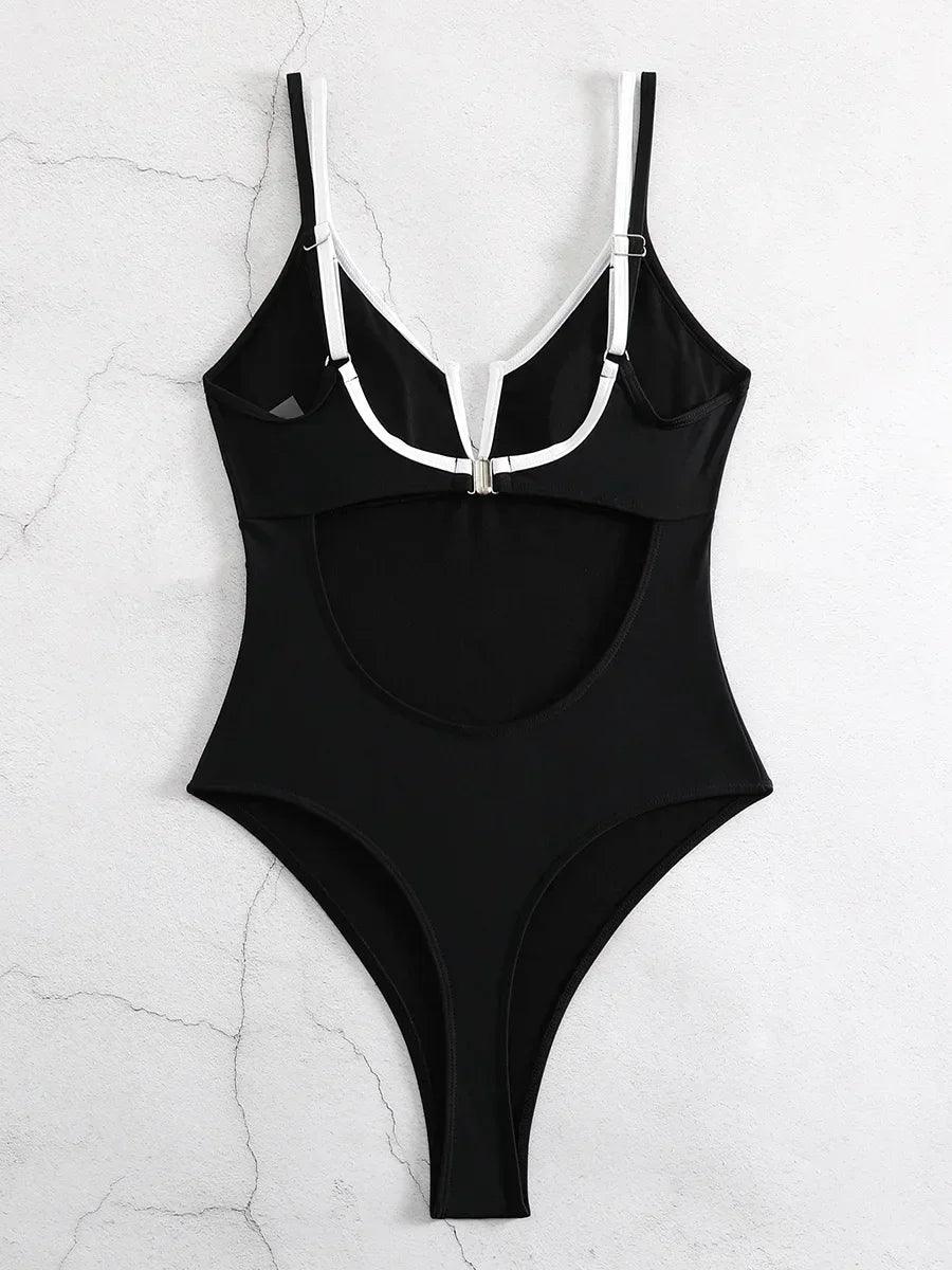 Black one-piece swimsuit with white straps and front zipper, stylish women's swimwear