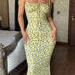 Yellow floral midi dress with tie straps, perfect for women's fashion and summer style