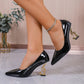 Black patent leather pumps with gold treble clef heels, stylish women's fashion footwear