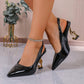 Black patent leather slingback heels with gold music note heels, worn with crystal anklet