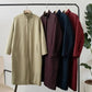 Women's long trench coats in beige, burgundy, navy, and red, displayed on rack for fashion store