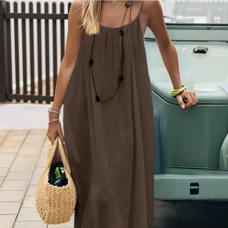 Woman in olive maxi dress with straw bag, boho summer fashion