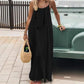 Woman in black spaghetti strap maxi dress with straw bag, summer fashion outfit