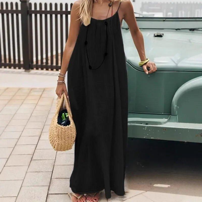 Woman in black spaghetti strap maxi dress with straw bag, summer fashion outfit