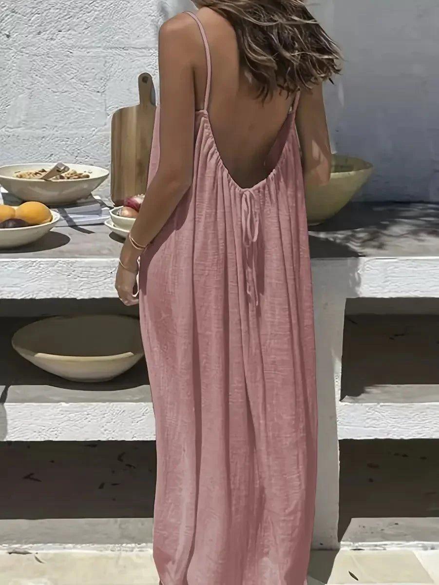 Woman in pink backless maxi dress, summer fashion, beach style, casual elegance